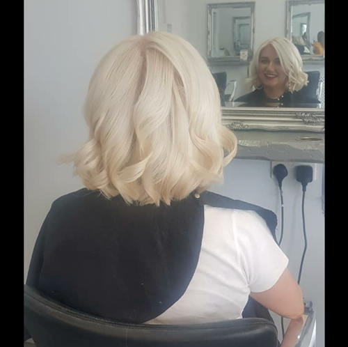 Hair dyed platinum blonde with curls